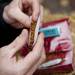 A Hash Bash patron rolls a tobacco cigarette on Saturday, April 6. Daniel Brenner I AnnArbor.com